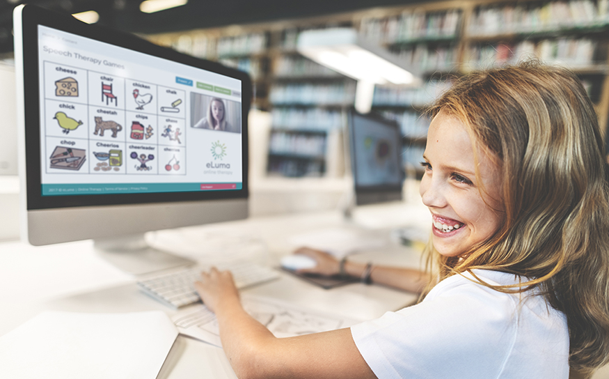 Girl smiling while working at computer
