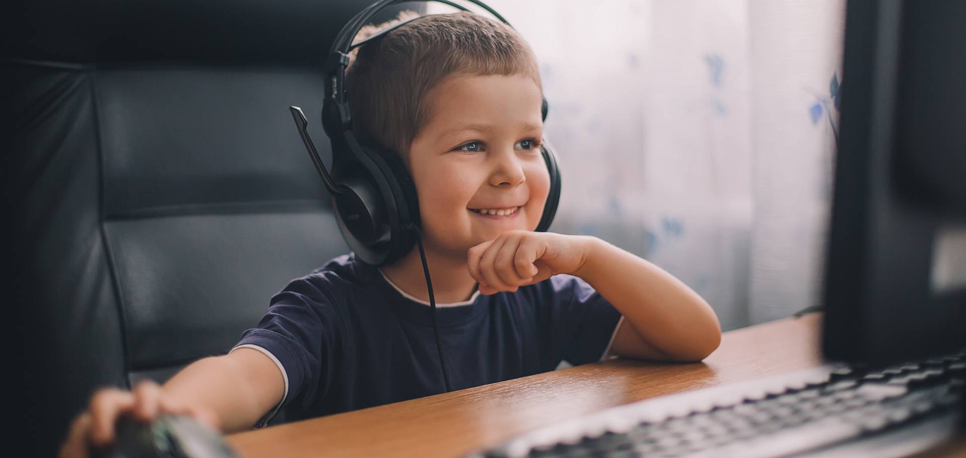 K-12 boy completing an online speech therapy session