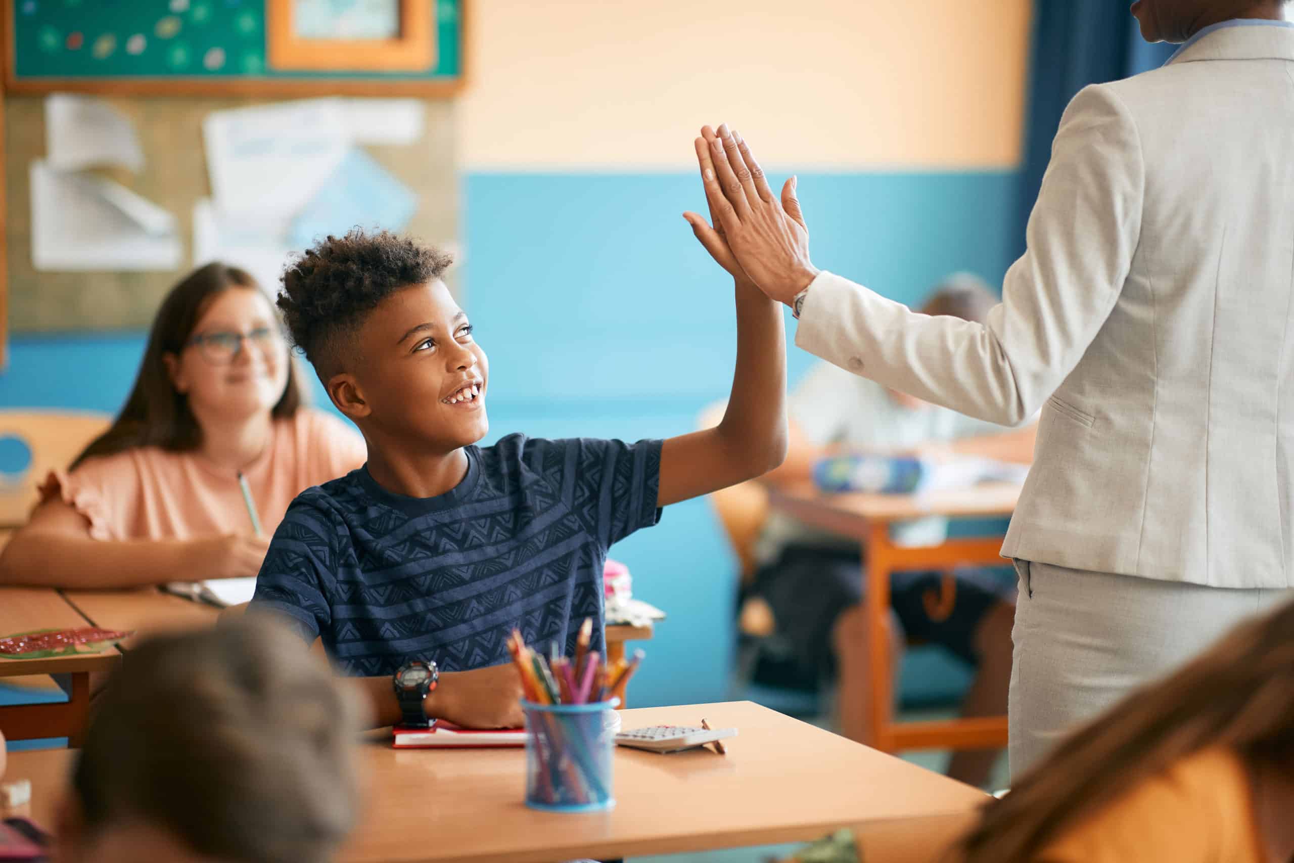 Successful Student High-fiving Educator